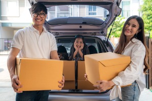 Family unpacking boxes at new home